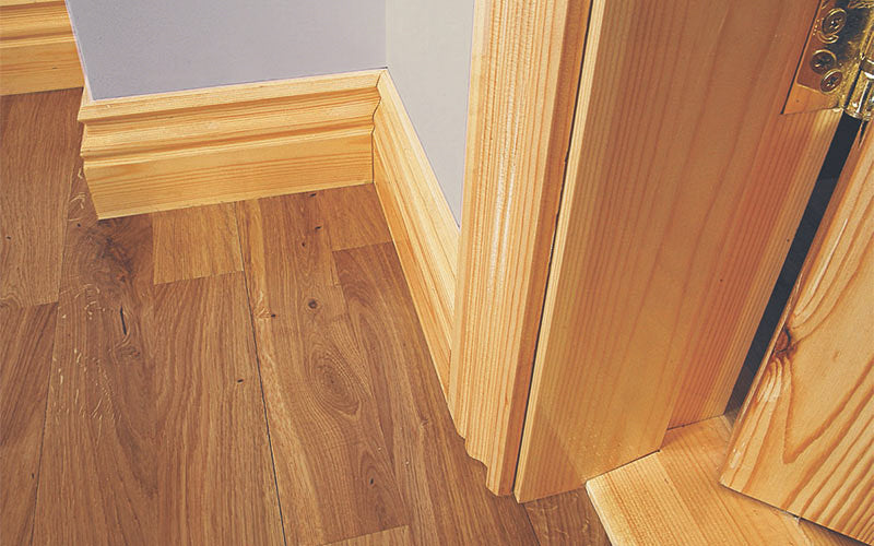 Pre-Varished Redwood Skirting Board, Architrave, Door Frame and Door Saddle fitted to a wall, showcasing the stylish and high-quality products provided by DIY Timber Packs