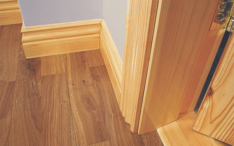 Pre-Varished Redwood Skirting Board, Architrave, Door Frame and Door Saddle fitted to a wall, showcasing the stylish and high-quality products provided by DIY Timber Packs