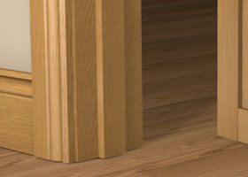 Pre-Varnished Solid Oak Door Frame shown fitted within a doorway, complimented by architrave on each side