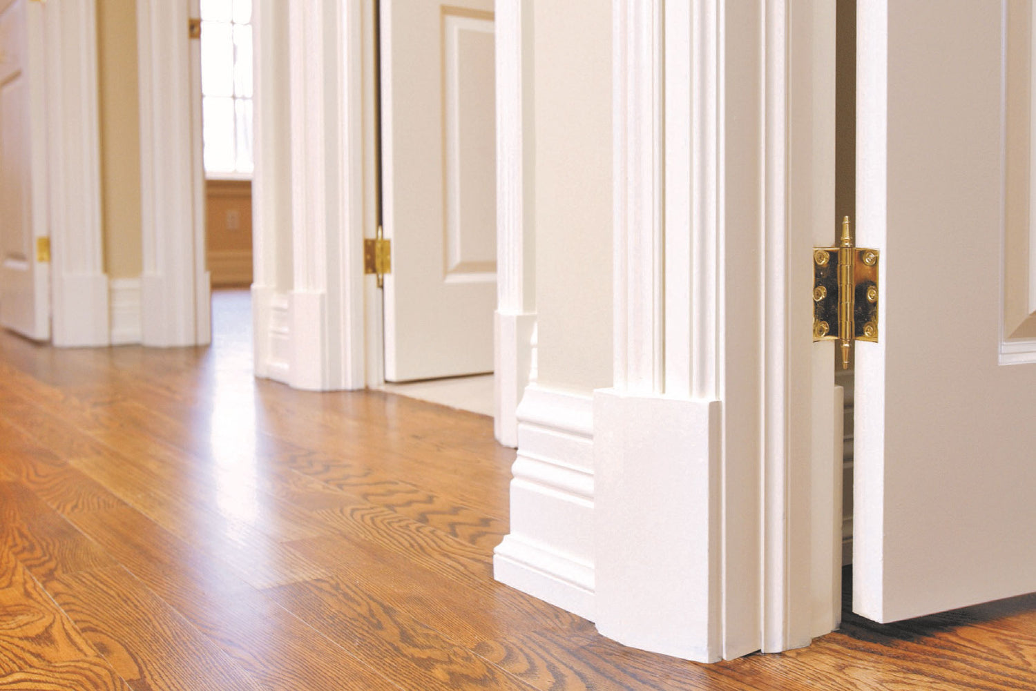 Pre-Painted White Pallas Skirting fitted to a wall contrasting with dark flooring, showcasing the stylish and high-quality products provided by DIY Timber Packs