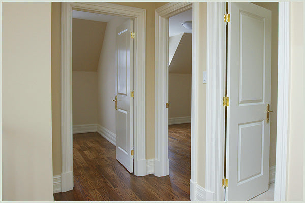 Pre-Painted White Pallas Skirting fitted to a wall contrasting with dark flooring